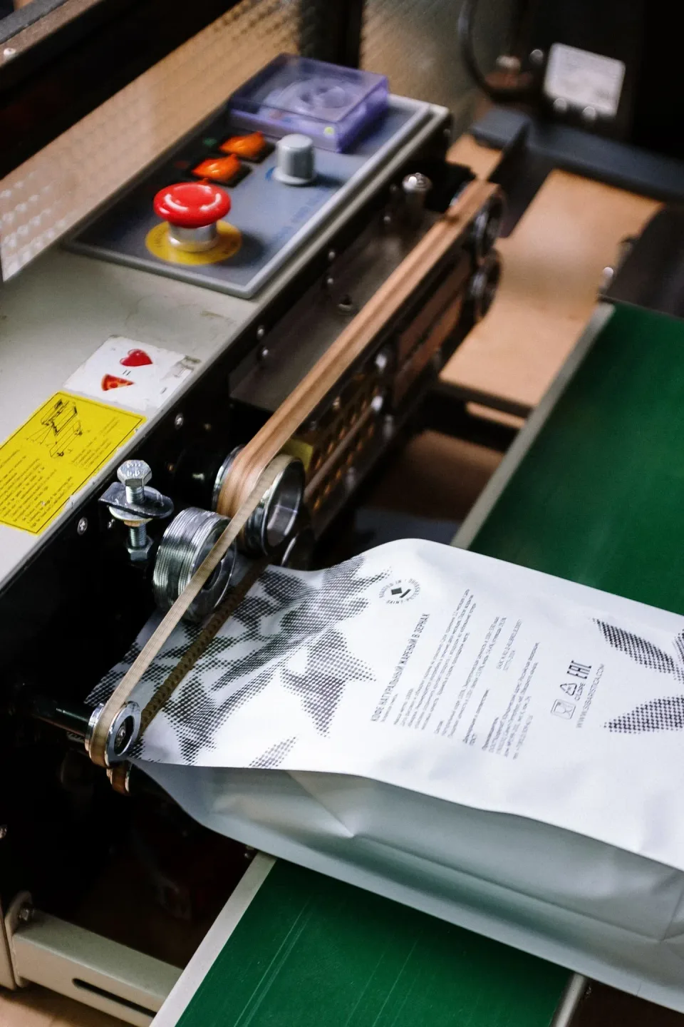 Packaging Machine — Industrial Manufacturing Packaging Machine — Industrial Manufacturing — Packaging Machine, Conveyor Belt, Emergency Stop Button, Industrial Manufactu…